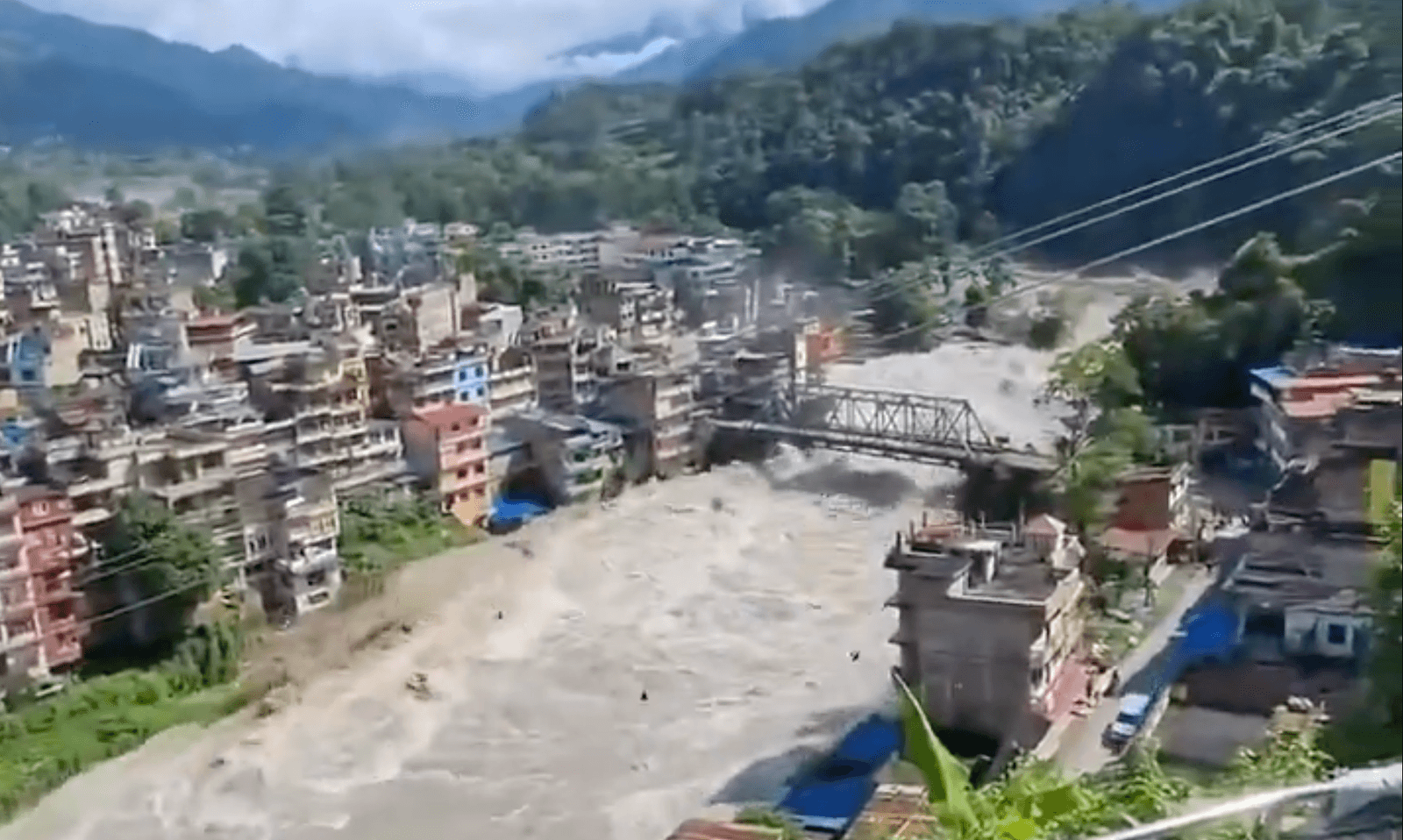 Flash floods rushing through residential areas along the banks of river in Nepal. 